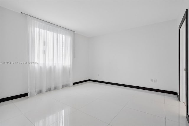 unfurnished room featuring light tile patterned floors