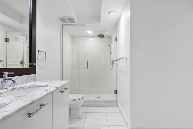 bathroom with toilet, vanity, tile patterned floors, and walk in shower