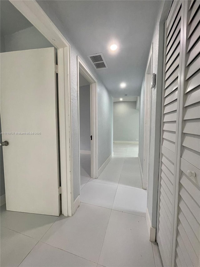 corridor featuring light tile patterned floors