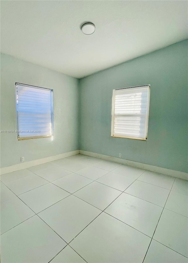 unfurnished room featuring light tile patterned floors