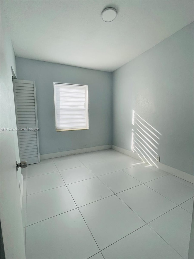 spare room with light tile patterned floors