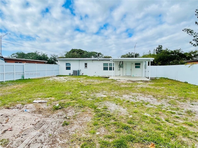 back of house featuring a yard, a patio, and central AC unit