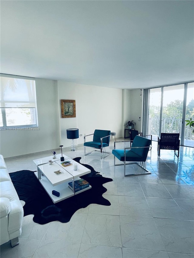 living room with light tile patterned flooring, a healthy amount of sunlight, and a wall of windows