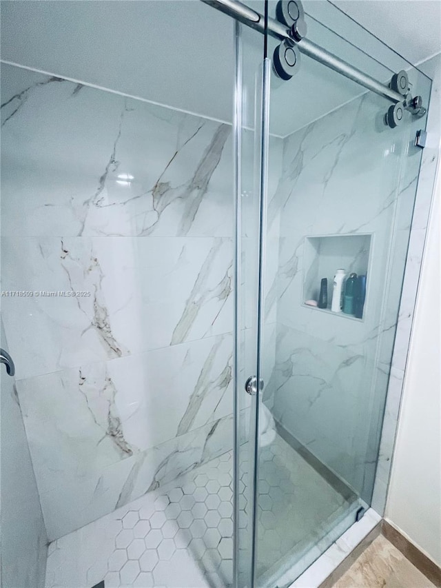 bathroom with a shower with shower door