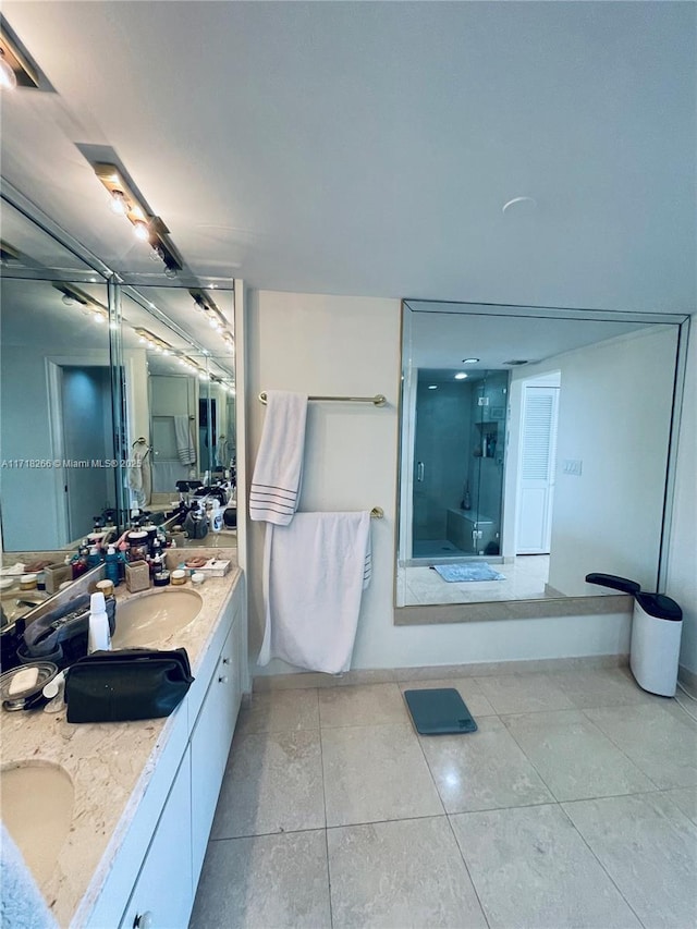 bathroom with tile patterned flooring, vanity, and walk in shower