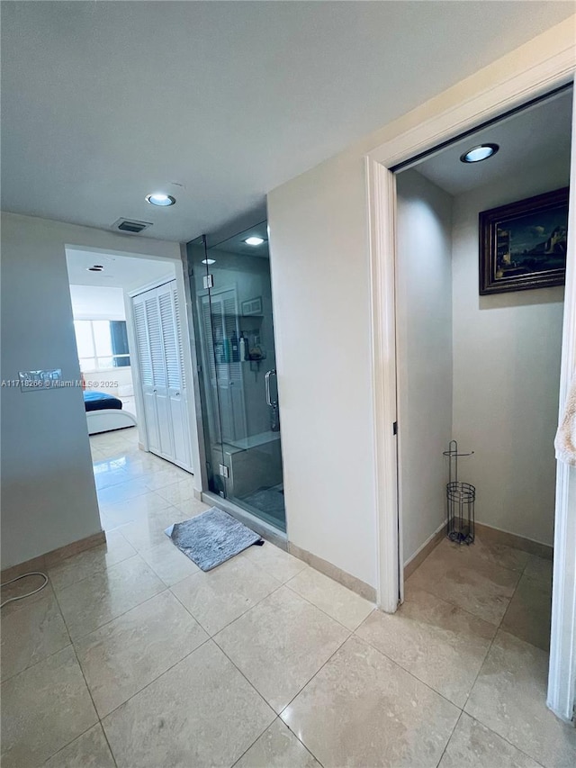 bathroom featuring a shower with shower door