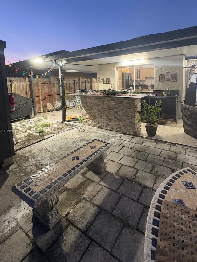 view of patio terrace at dusk