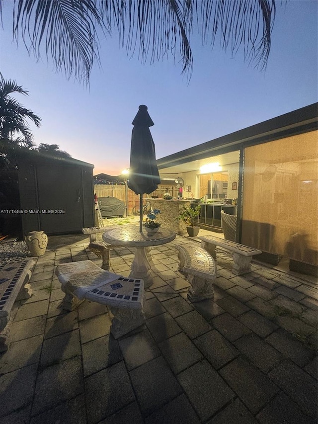 view of patio terrace at dusk