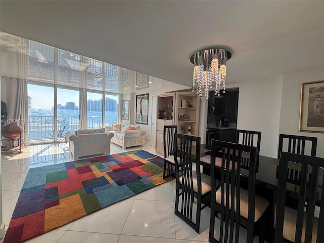 tiled dining room with a chandelier