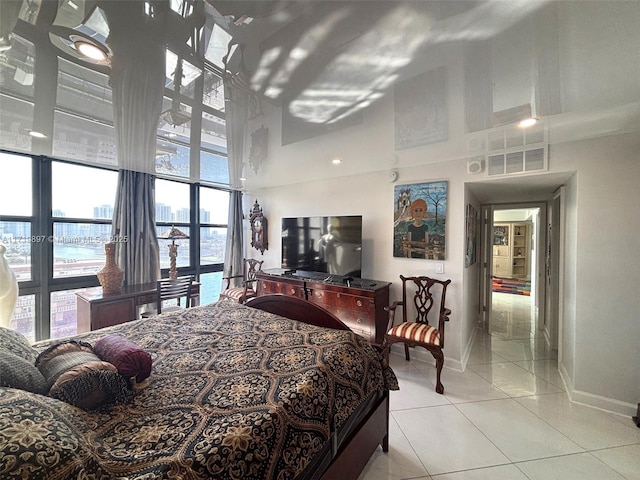 bedroom featuring light tile patterned floors and a high ceiling