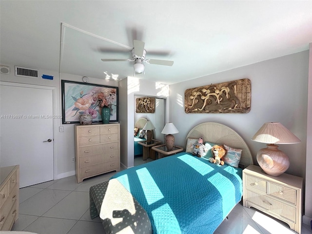 tiled bedroom featuring ceiling fan