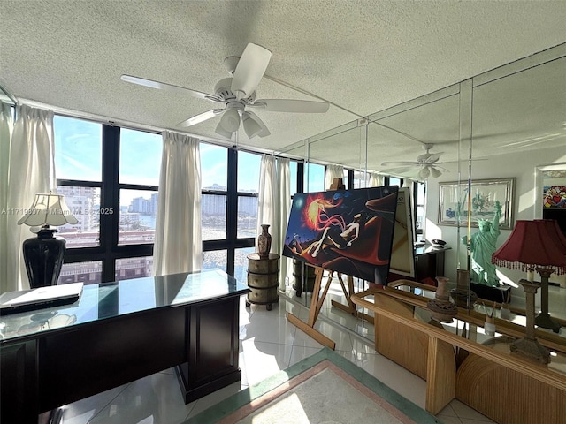 interior space featuring ceiling fan, floor to ceiling windows, a textured ceiling, and french doors