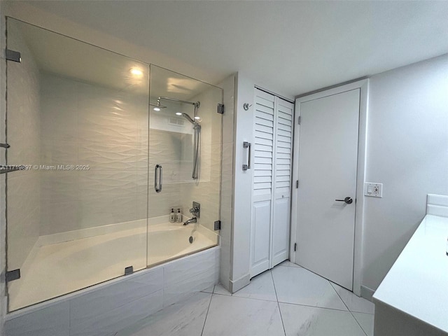 bathroom with vanity and bath / shower combo with glass door