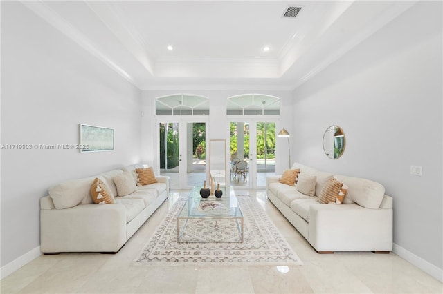 living room featuring french doors, a tray ceiling, and crown molding