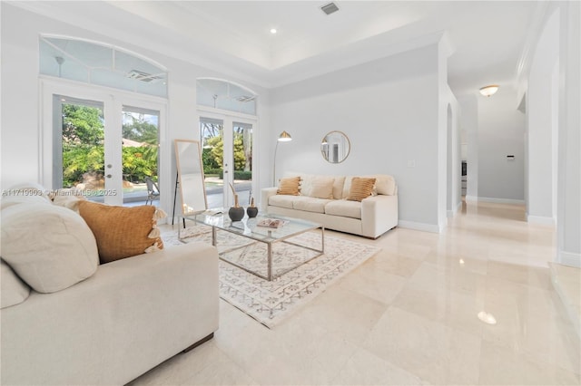 living room featuring french doors, a raised ceiling, a wealth of natural light, and crown molding