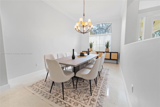 dining area with crown molding and an inviting chandelier