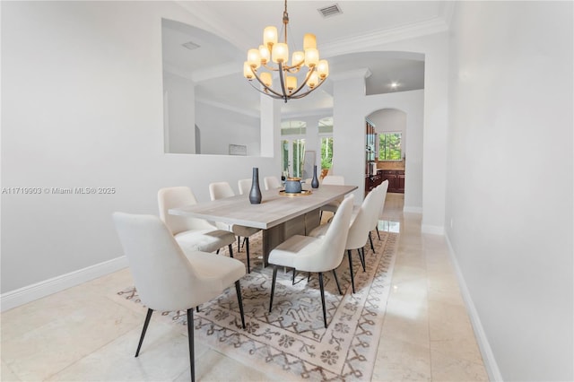 dining room with crown molding and an inviting chandelier