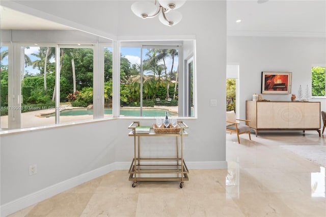 interior space featuring a healthy amount of sunlight and ornamental molding