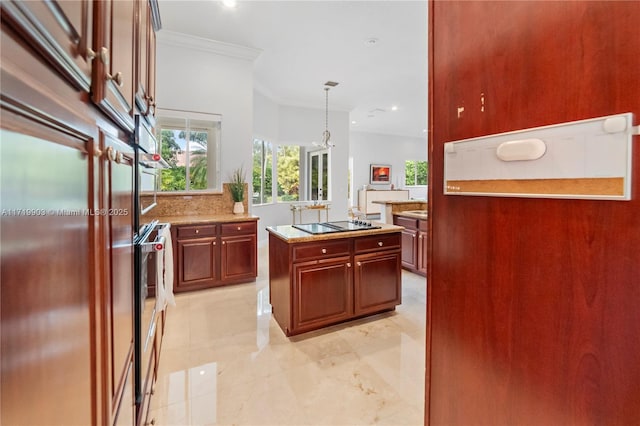 kitchen with a kitchen island, black electric stovetop, tasteful backsplash, hanging light fixtures, and crown molding