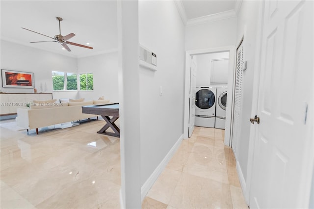 corridor featuring ornamental molding and washing machine and dryer