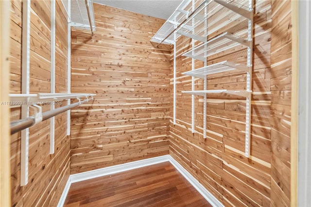 walk in closet with hardwood / wood-style floors