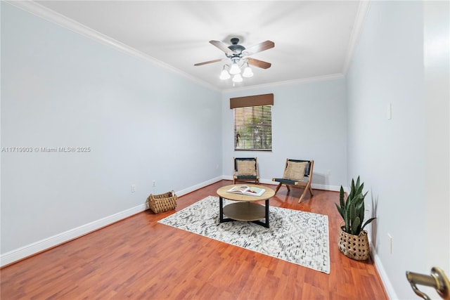 sitting room featuring hardwood / wood-style flooring, crown molding, and ceiling fan