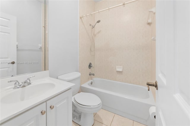 full bathroom with toilet, tile patterned floors, vanity, and tiled shower / bath