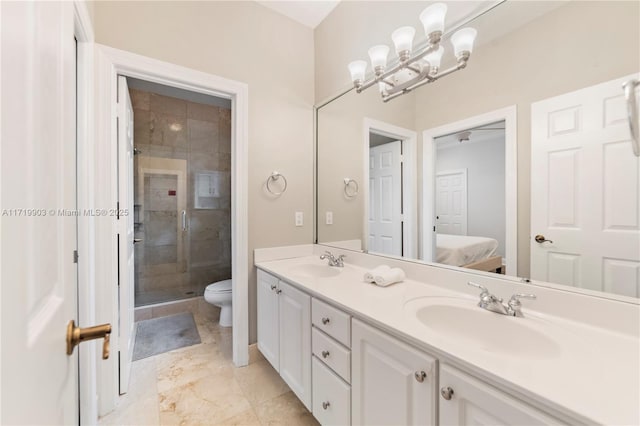 bathroom with toilet, a shower with door, an inviting chandelier, and vanity