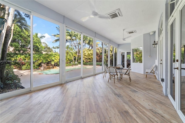 unfurnished sunroom with ceiling fan and a wealth of natural light