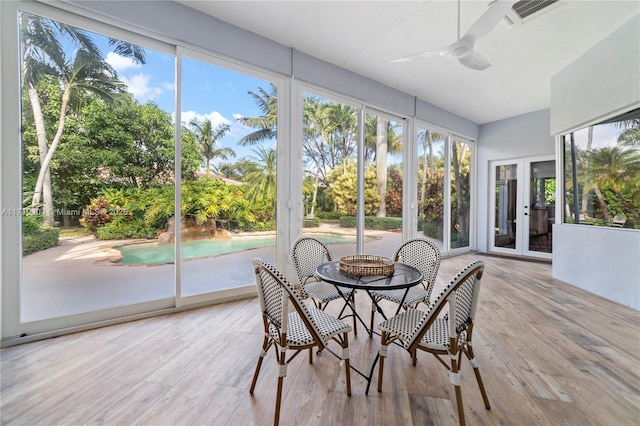 sunroom featuring ceiling fan and french doors