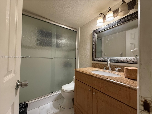 bathroom featuring tile patterned flooring, a textured ceiling, toilet, vanity, and a shower with shower door