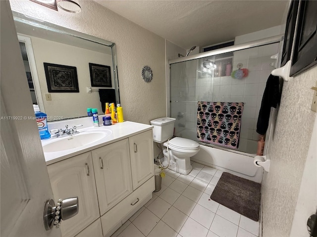 full bathroom featuring enclosed tub / shower combo, tile patterned floors, a textured ceiling, toilet, and vanity