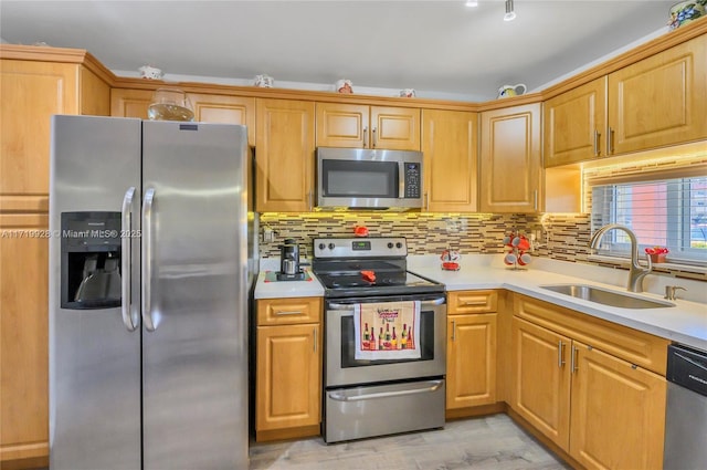 kitchen featuring backsplash, stainless steel appliances, light hardwood / wood-style flooring, and sink