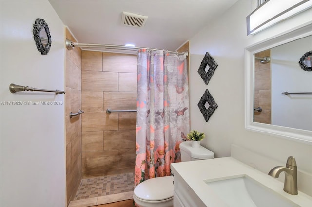 bathroom with a shower with shower curtain, vanity, and toilet