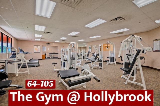 exercise room with a paneled ceiling and carpet floors