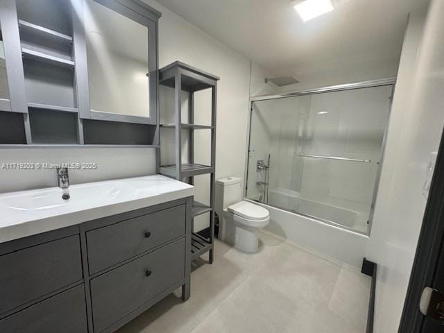 full bathroom featuring vanity, toilet, and shower / bath combination with glass door