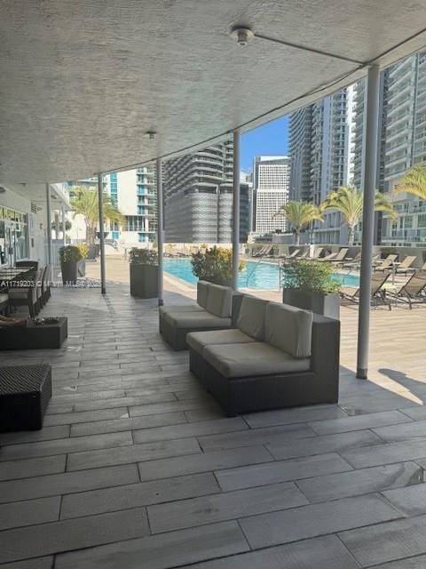 view of patio with an outdoor living space and a community pool