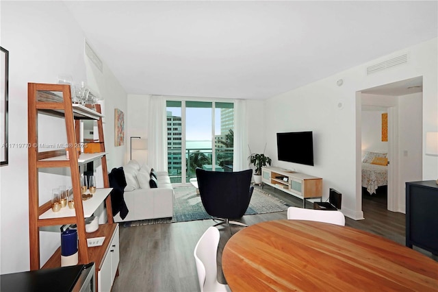 living room with floor to ceiling windows and dark hardwood / wood-style floors