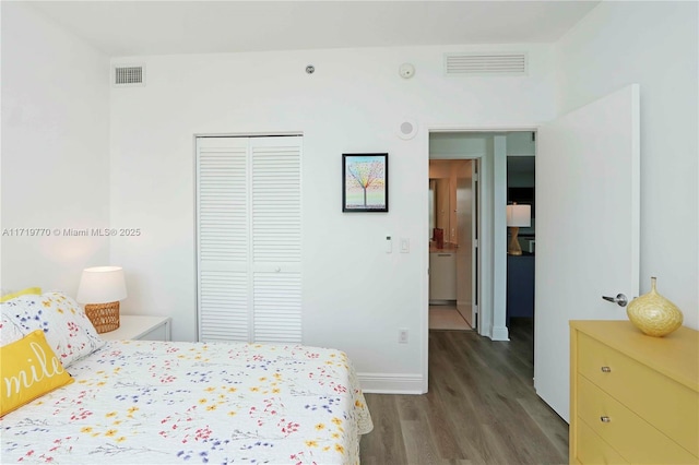 bedroom featuring a closet and dark hardwood / wood-style floors