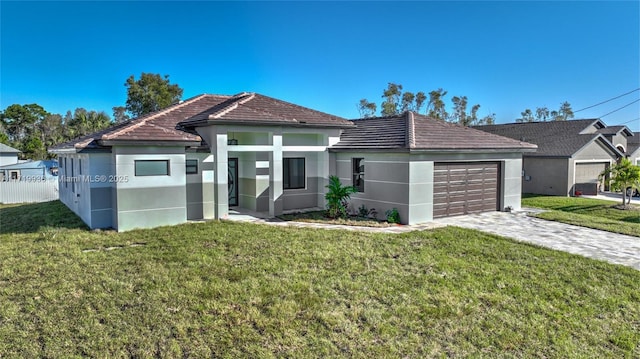 view of front of house with a front yard and a garage