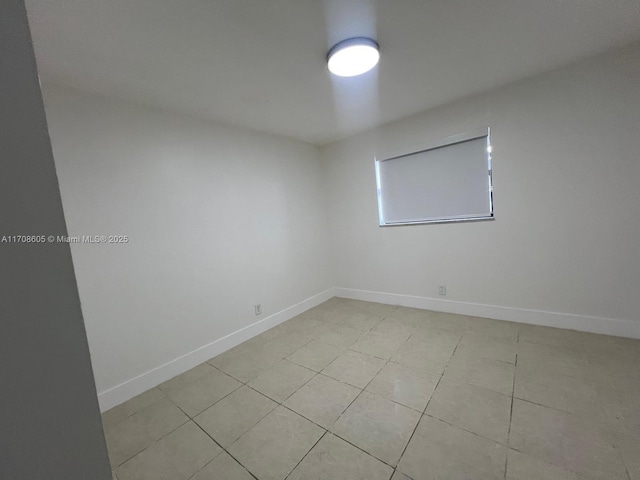 empty room with light tile patterned floors