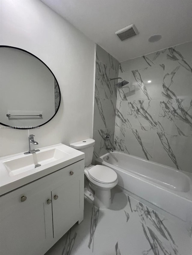 full bathroom featuring vanity, tiled shower / bath combo, and toilet