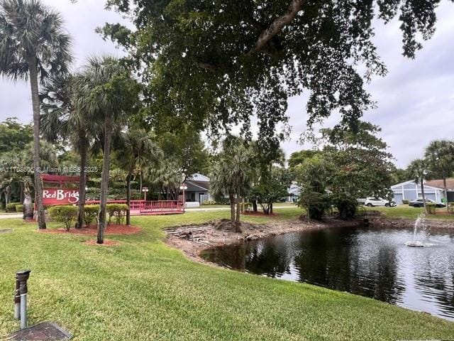 surrounding community featuring a yard and a water view