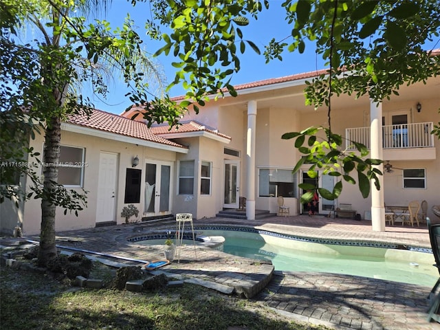 rear view of property featuring french doors and a patio