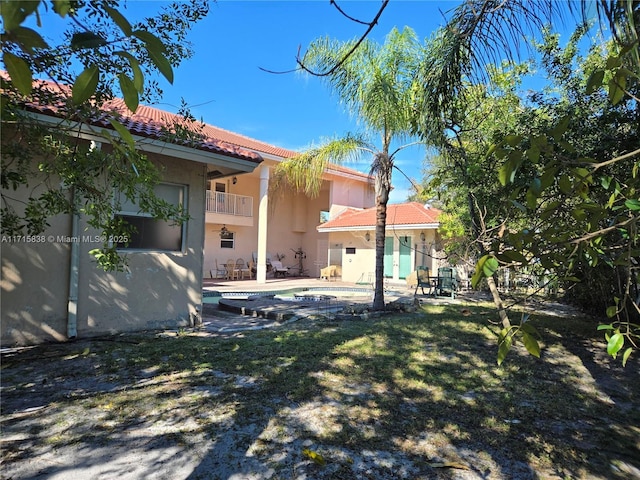 view of yard with a balcony and a patio