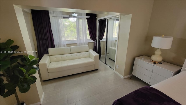 bedroom featuring light tile patterned floors and a closet