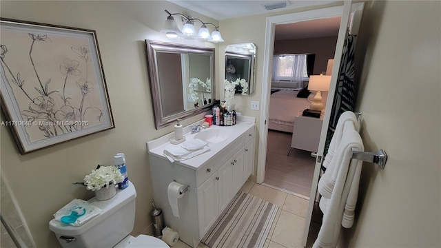 bathroom featuring tile patterned flooring, vanity, and toilet