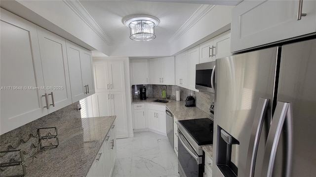 kitchen with light stone countertops, white cabinetry, and stainless steel appliances