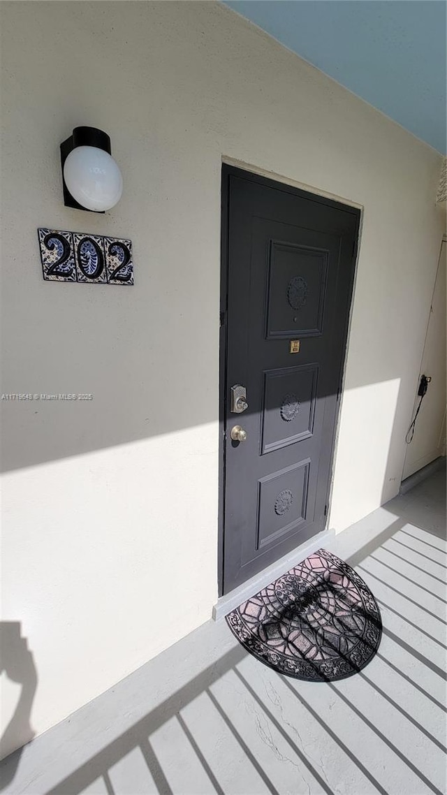 doorway to property featuring a porch