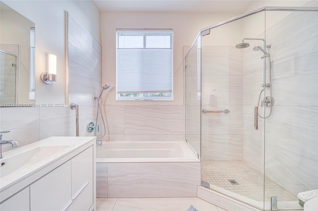 bathroom with shower with separate bathtub and vanity